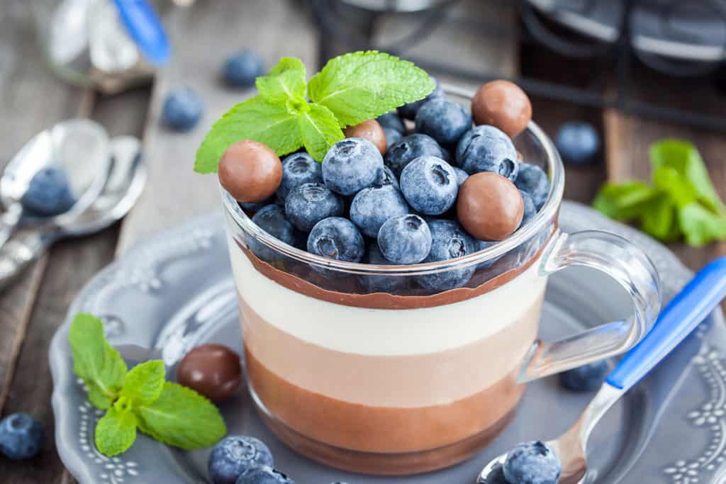 Delicious three layered chocolate mousse dessert, devorated wit