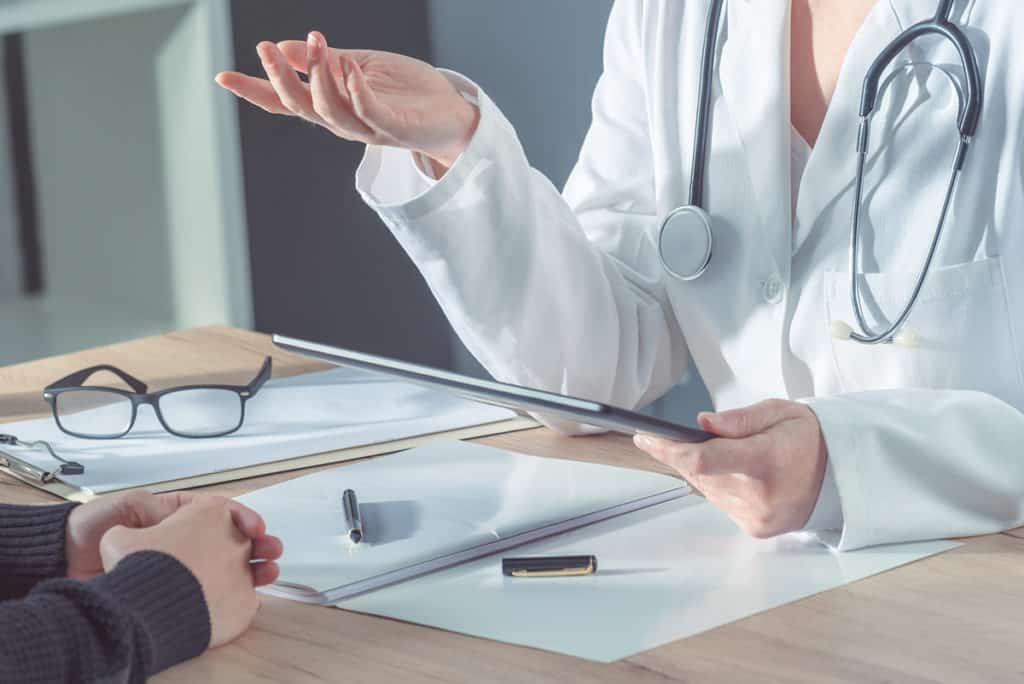 Doctor advising patient in hospital office