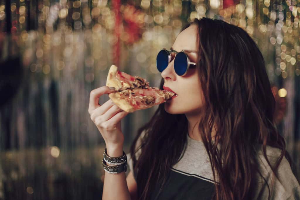 Girl eating tasty pizza